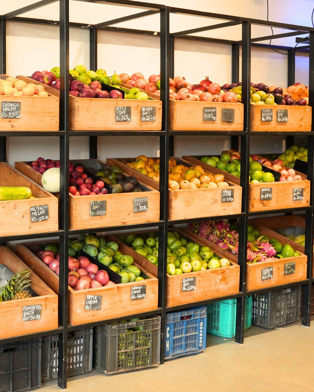 Wooden crates of fresh fruit stacked along the fruit wall