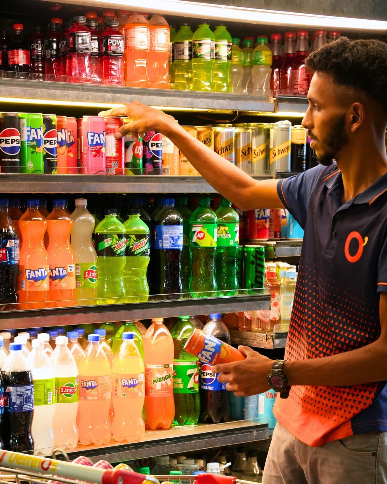 A Delfino's team member stocking the soft drinks